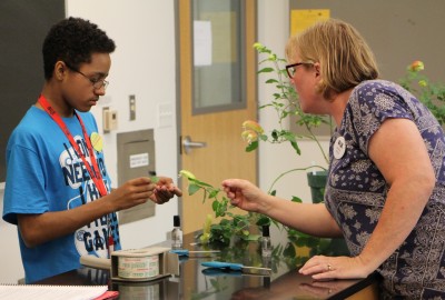 A 2018 OWjL camper studies plants with his teacher, OWU's Barb Wiehe.